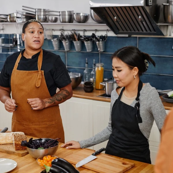 two diverse people in a kitchen cooking